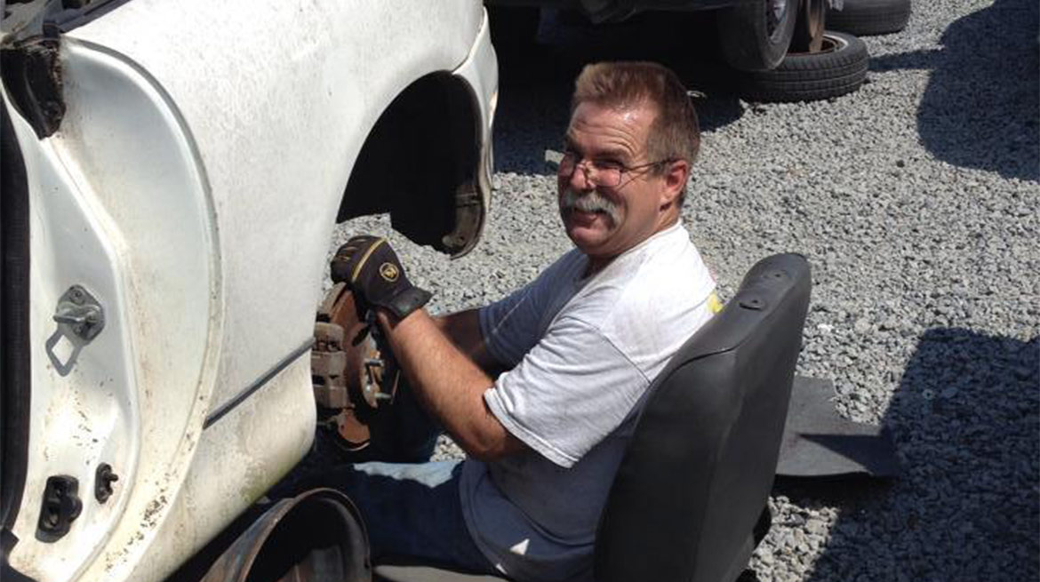 Man replacing rotor on car