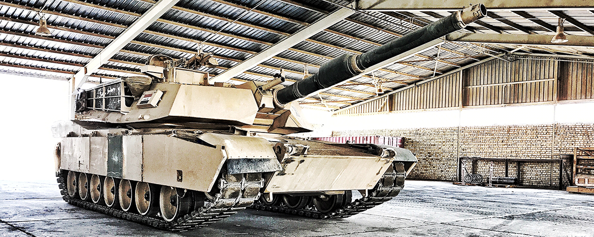 Abrams tank parked in a garage