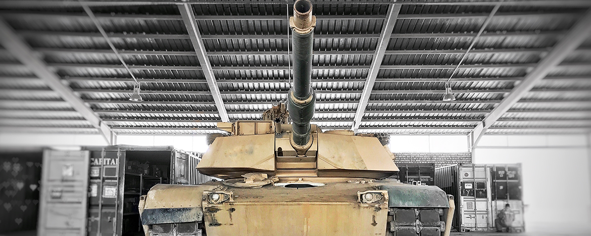 Abrams tank parked in a garage