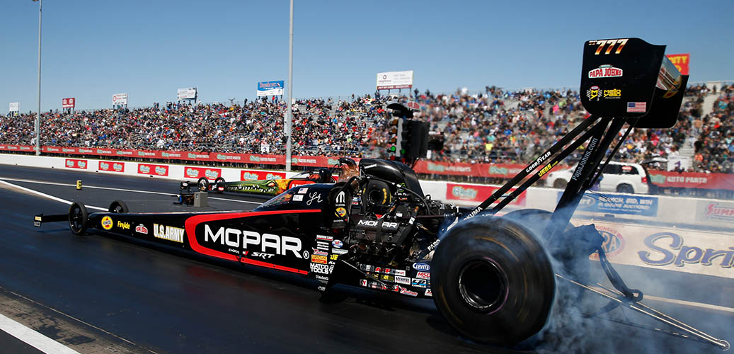 Leah Pritchett racing down the track in her Dodge Mopar Top Fuel dragster