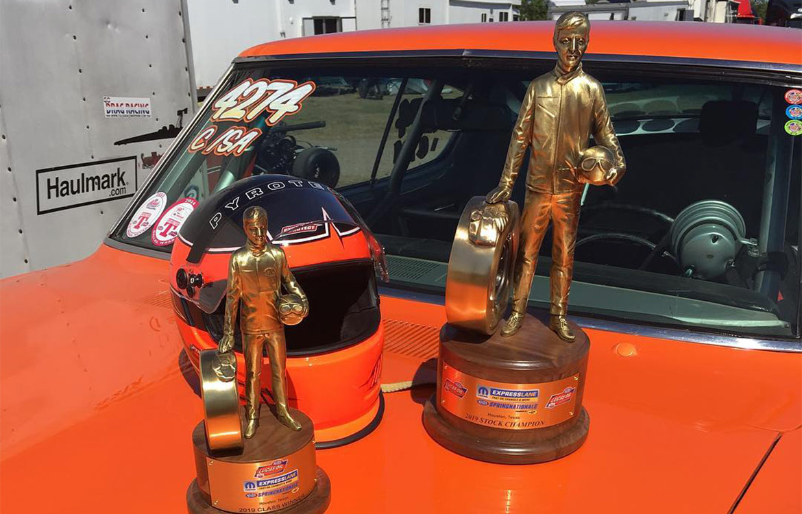 Sportman trophies on the hood of an orange HEMI Challenger