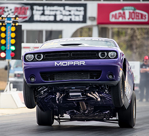 Purple Challenger doing a wheelie off the start line