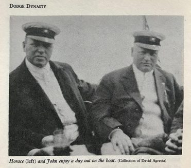 Horace and John Dodge sitting on a boat with sailor caps on