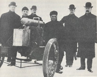 Henry Ford with his early race car. John Dodge all the way on the left.