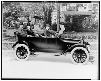 Horace & John Dodge being driven in the very first Dodge Brothers car, 1914