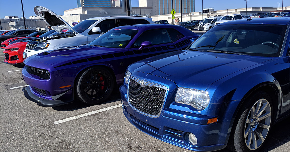 Rows of cars and crowds of people at Cars & Coffee Minnesota