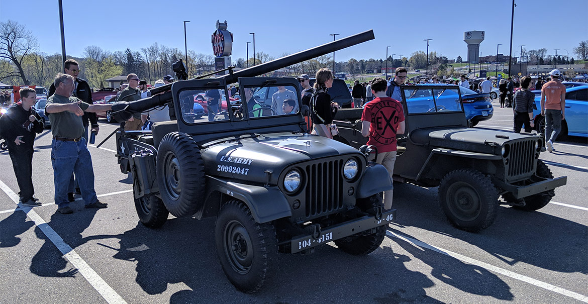 Jeep military vehicles with a crowd around