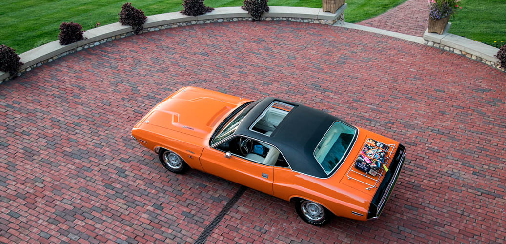 Orange 1970 Dodge Challenger with black top and sunroof