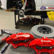 Set of red Brembo brakes sitting on a table waiting to be installed on the Durango SRT Pursuit
