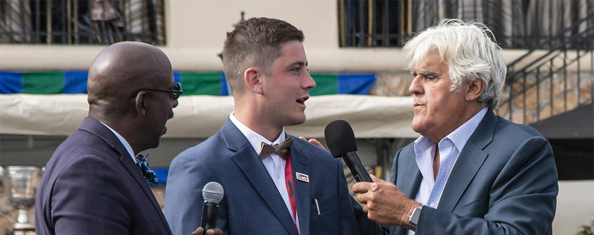 Lucas Jez is interviewed by Jay Leno and Donald Osborne on the Pebble Beach stage before the 2018 awards presentation