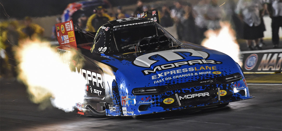 Mopar Express Lane Dodge Charger Hellcat Funny Car racing down the track with flames shooting out of the sides