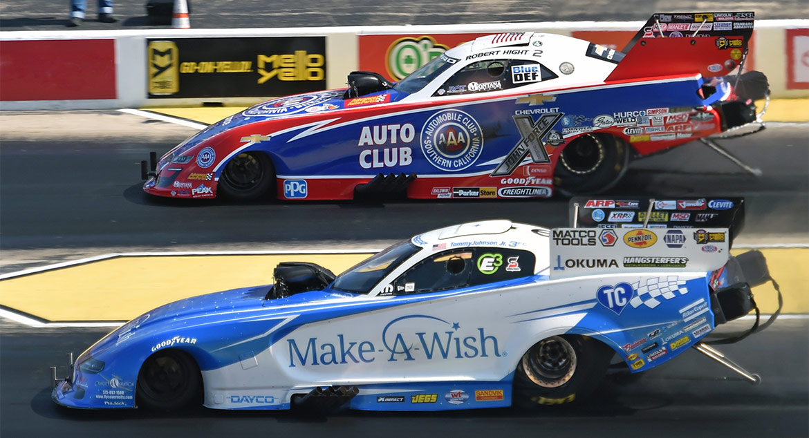 Two funny cars racing down the track at NHRA Route 66