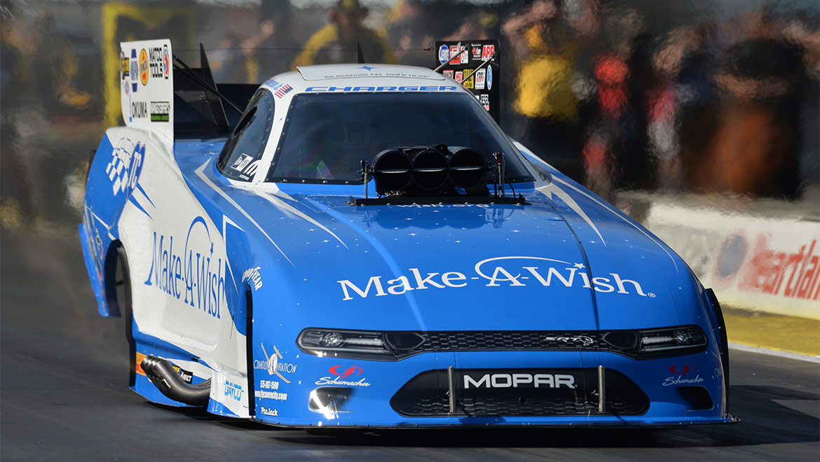 Tommy Johnson Jr racing his Make A Wish Dodge Charger SRT Hellcat Funny Car at NHRA Heartland Nationals