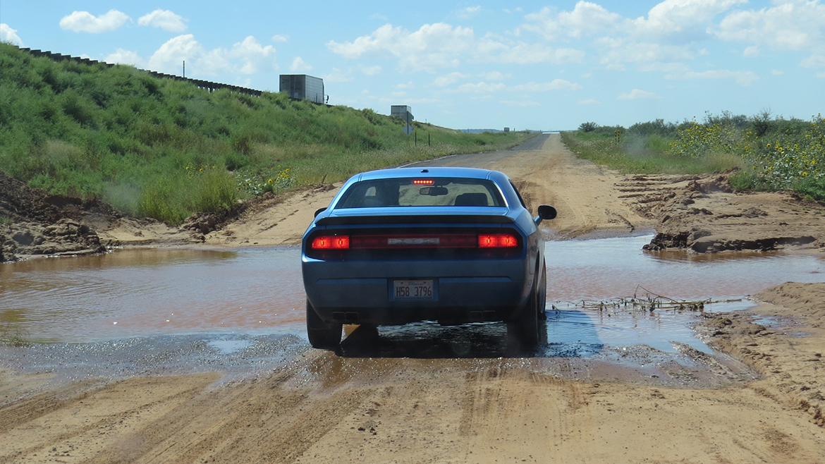 a 2009 Challenger R/T Classic in B5 Blue on a dirt road