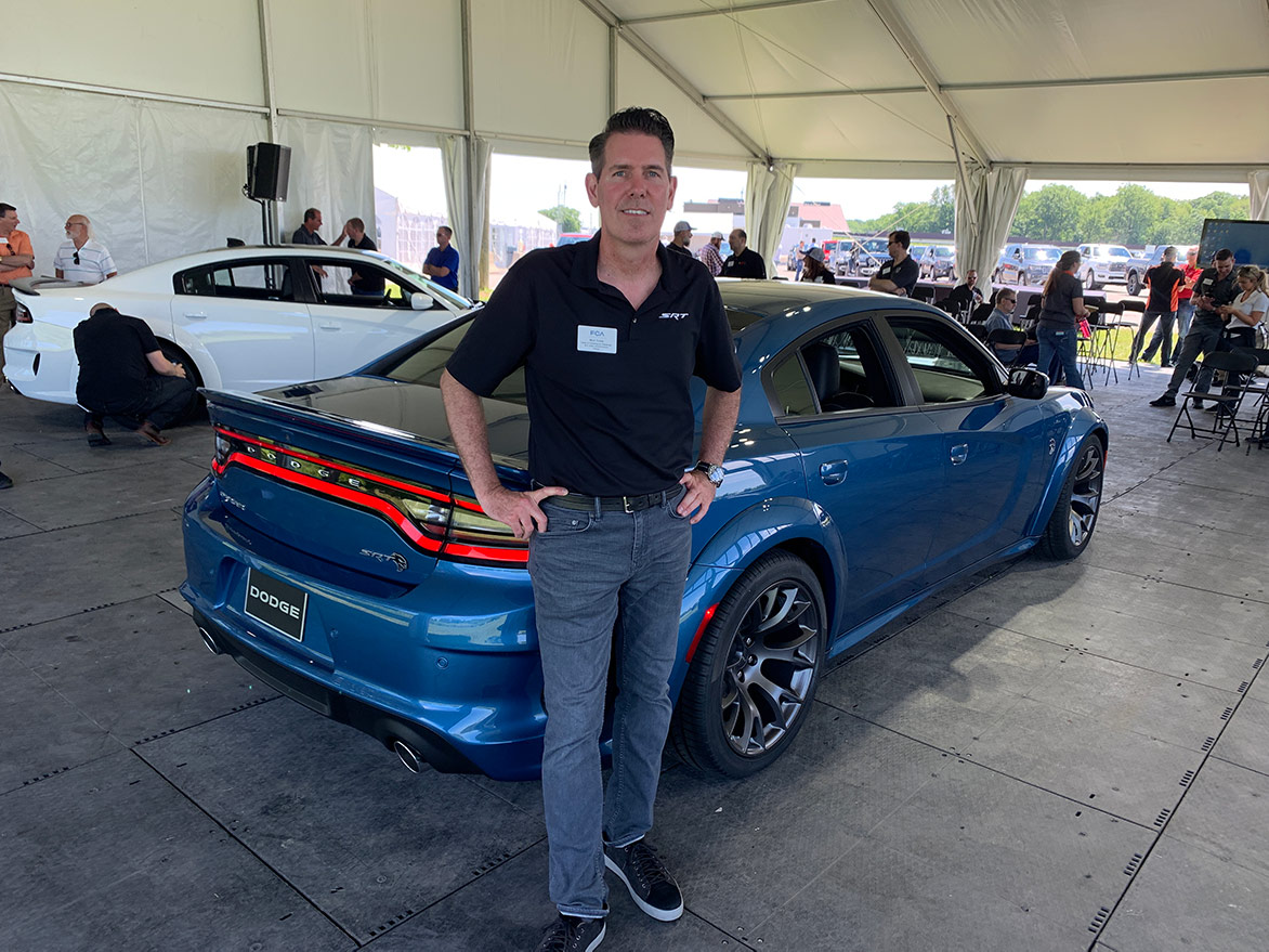 one man standing in front of a 2020 Charger Hellcat Widebody