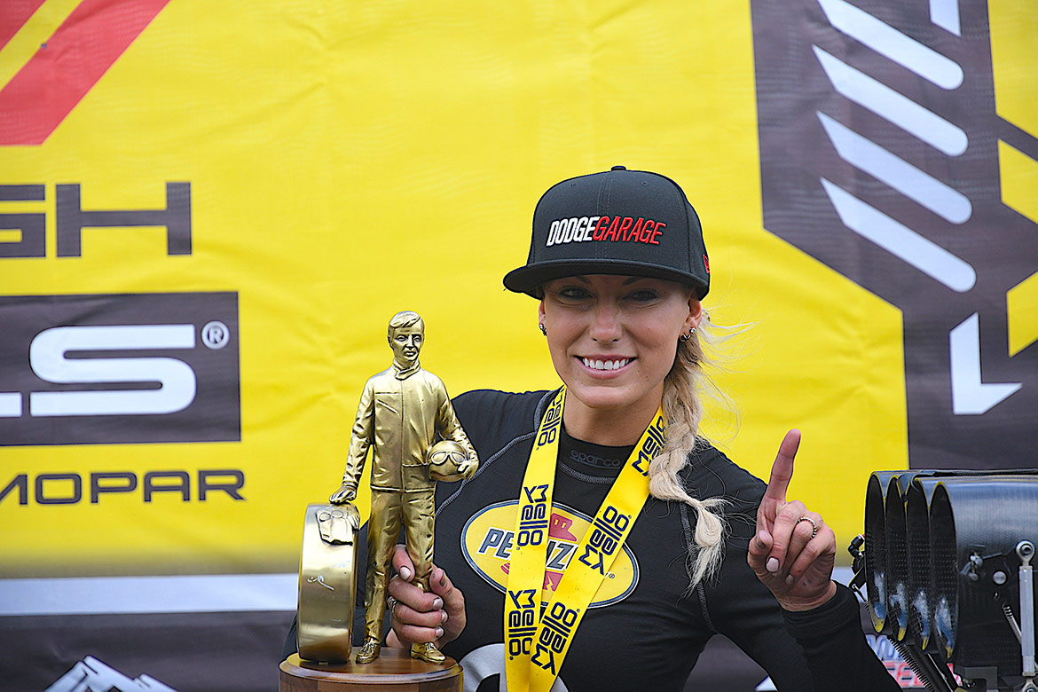 woman holding up trophy