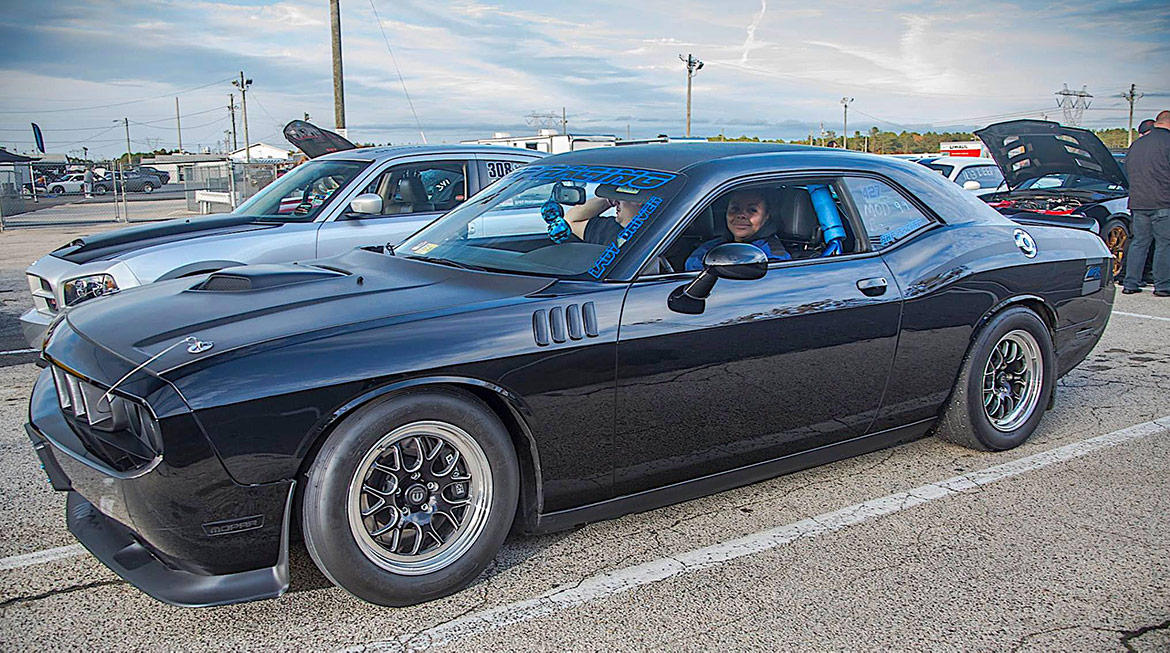 2013 woman sitting in her black Dodge Challenger R/T Classic