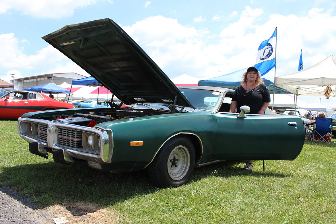 woman standing near her 1973 Dodge Charger SE