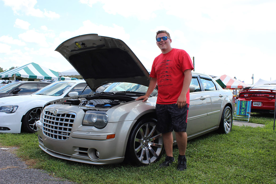man standing next to his 2005 Chrysler 300