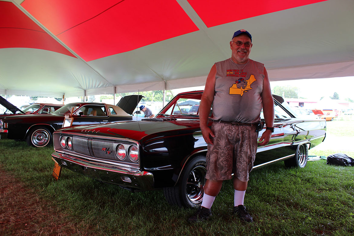 man standing next to his 1966 Coronet R/T Survivor HEMI Car