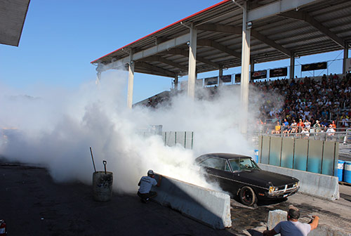 vehicle doing a burnout in a grand stand