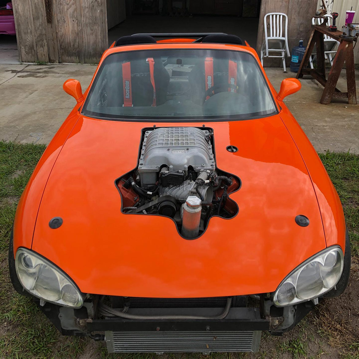 an orange vehicle parked outside a work garage