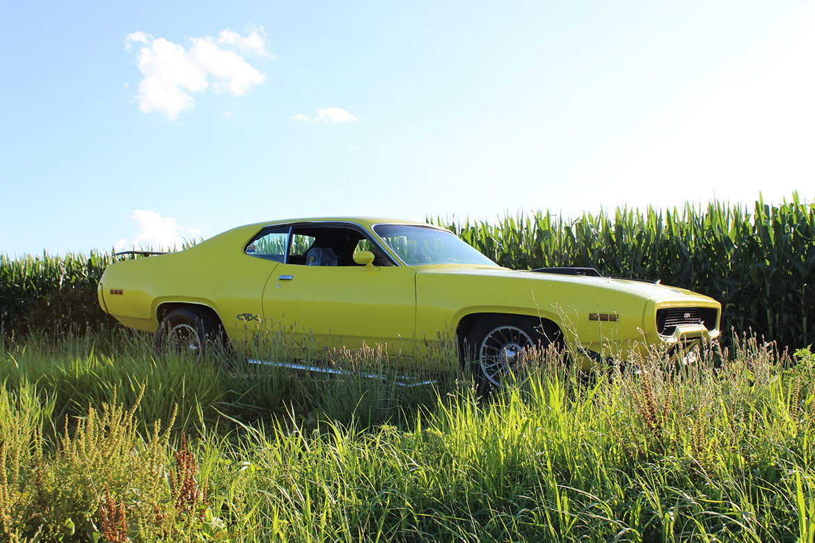 yellow 1971 Plymouth GTX parked outside