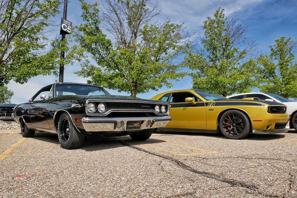 two dodge brand vehicles parked side by sided outdoors