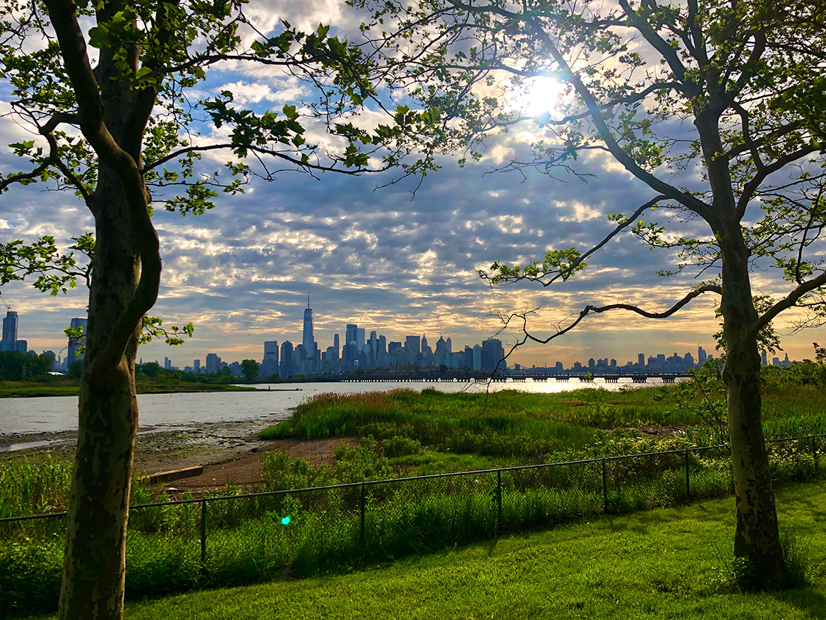 sunrise over the hudson river with the city skyline in the background