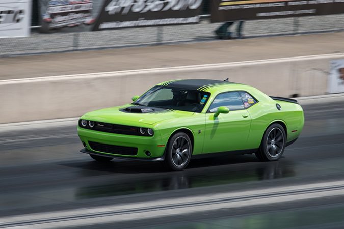 dodge vehicle racing down a drag strip