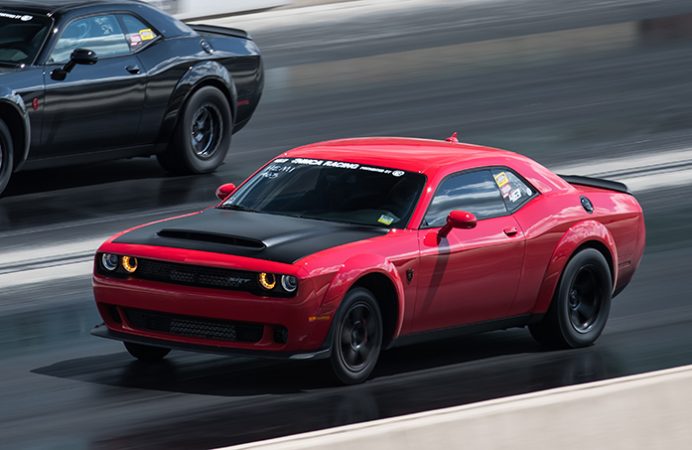 dodge vehicles racing down a drag strip