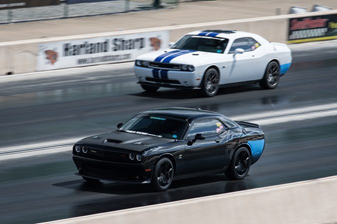 dodge vehicles racing down a drag strip