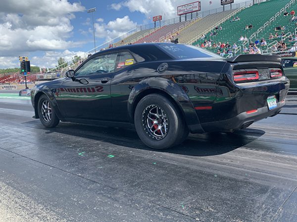 dodge vehicle racing down a drag strip