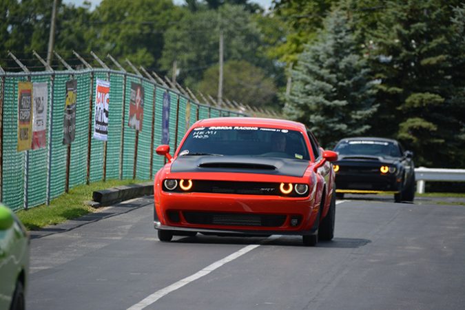 dodge vehicle racing down a drag strip