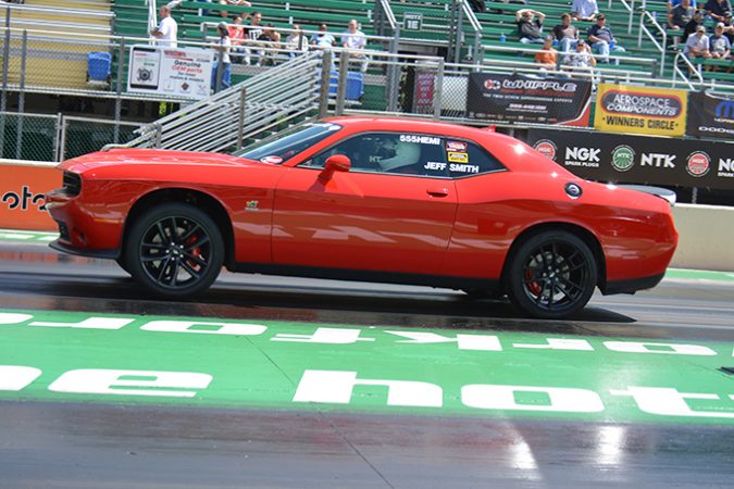 dodge vehicle racing down a drag strip