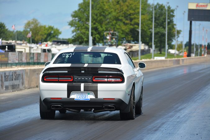 dodge vehicle racing down a drag strip