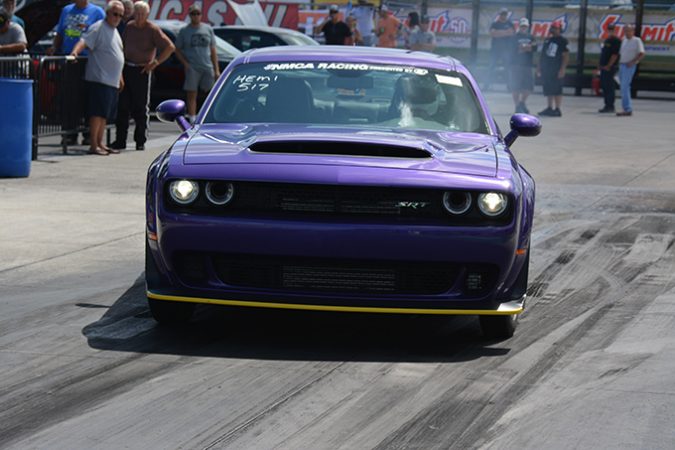 dodge vehicle racing down a drag strip