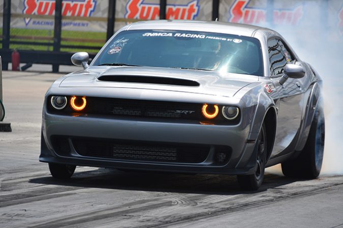 dodge vehicle racing down a drag strip