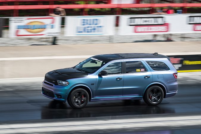 dodge vehicle racing down a drag strip