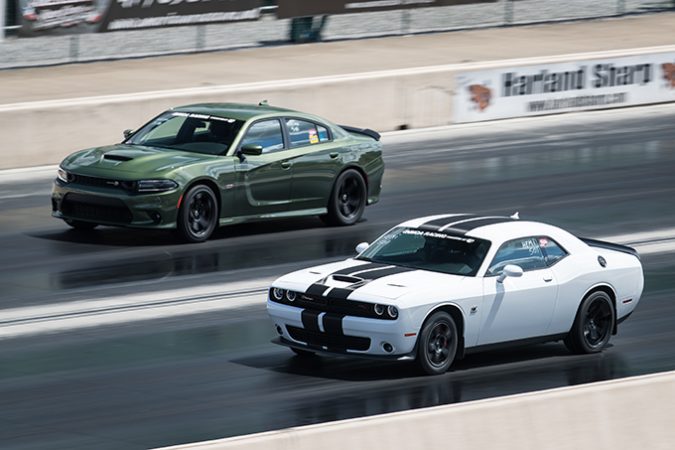 dodge vehicles racing down a drag strip