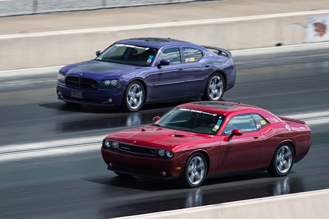 dodge vehicles racing down a drag strip