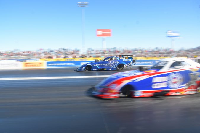 two funny cars coming off the starting line