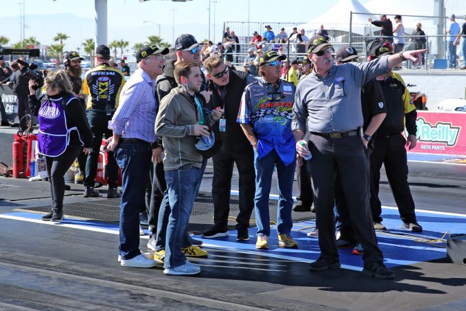 group standing on the starting line of the drag strip
