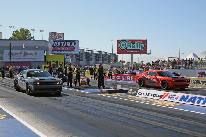 dodge challengers on the starting line of a drag strip