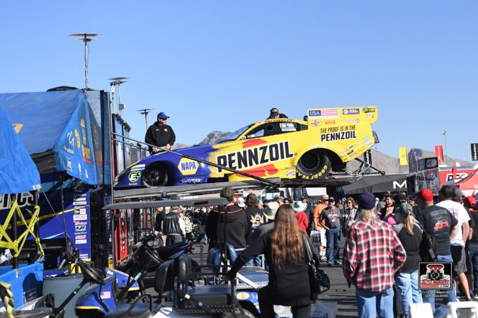 funny car being lifted out of a trailer
