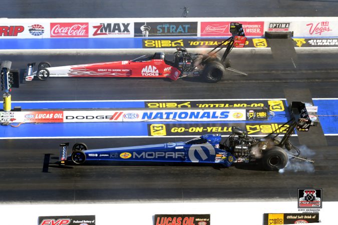 top fuel dragsters at the starting line of a drag strip