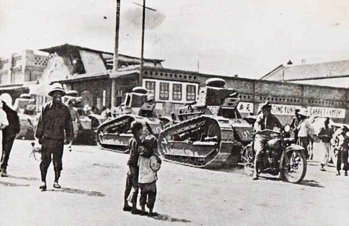 parade of tanks as people look on