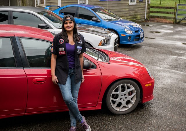 Jovita standing beside her red Dodge Neon