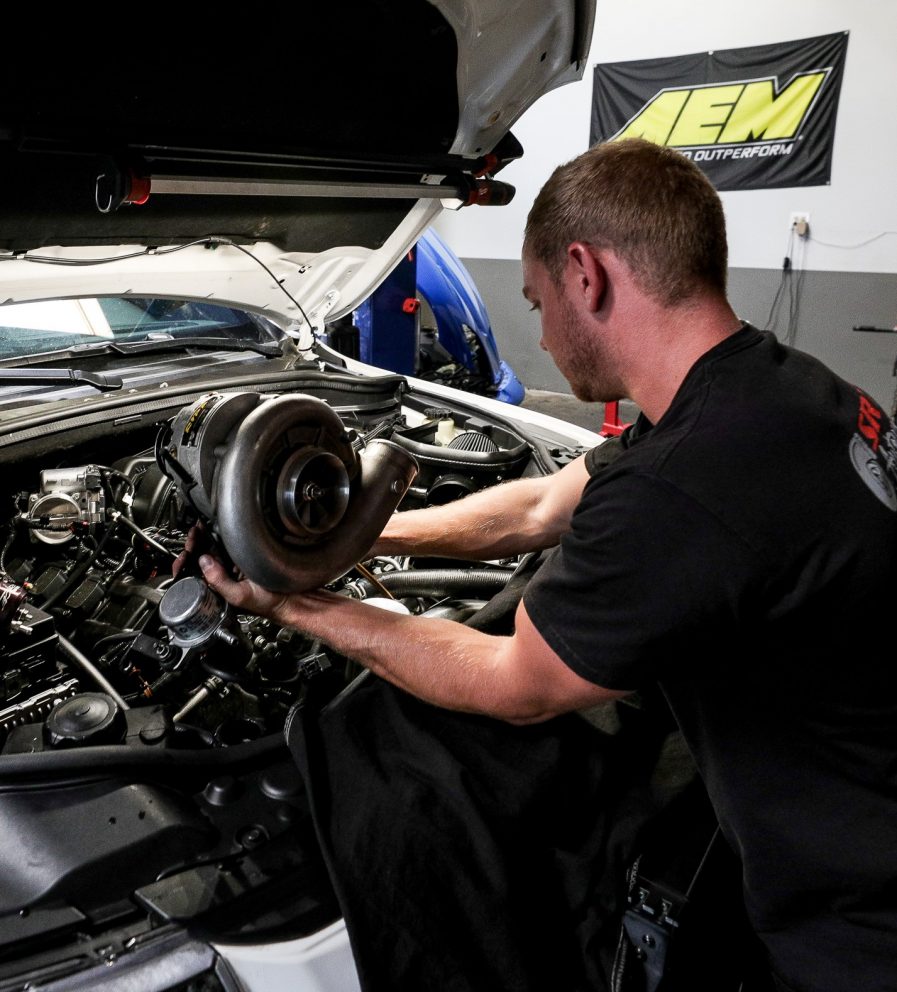 man working on vehicle parts