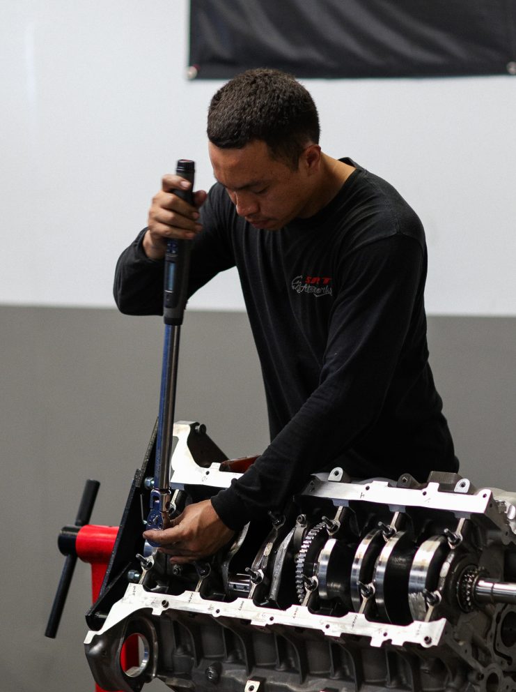 man working on vehicle parts